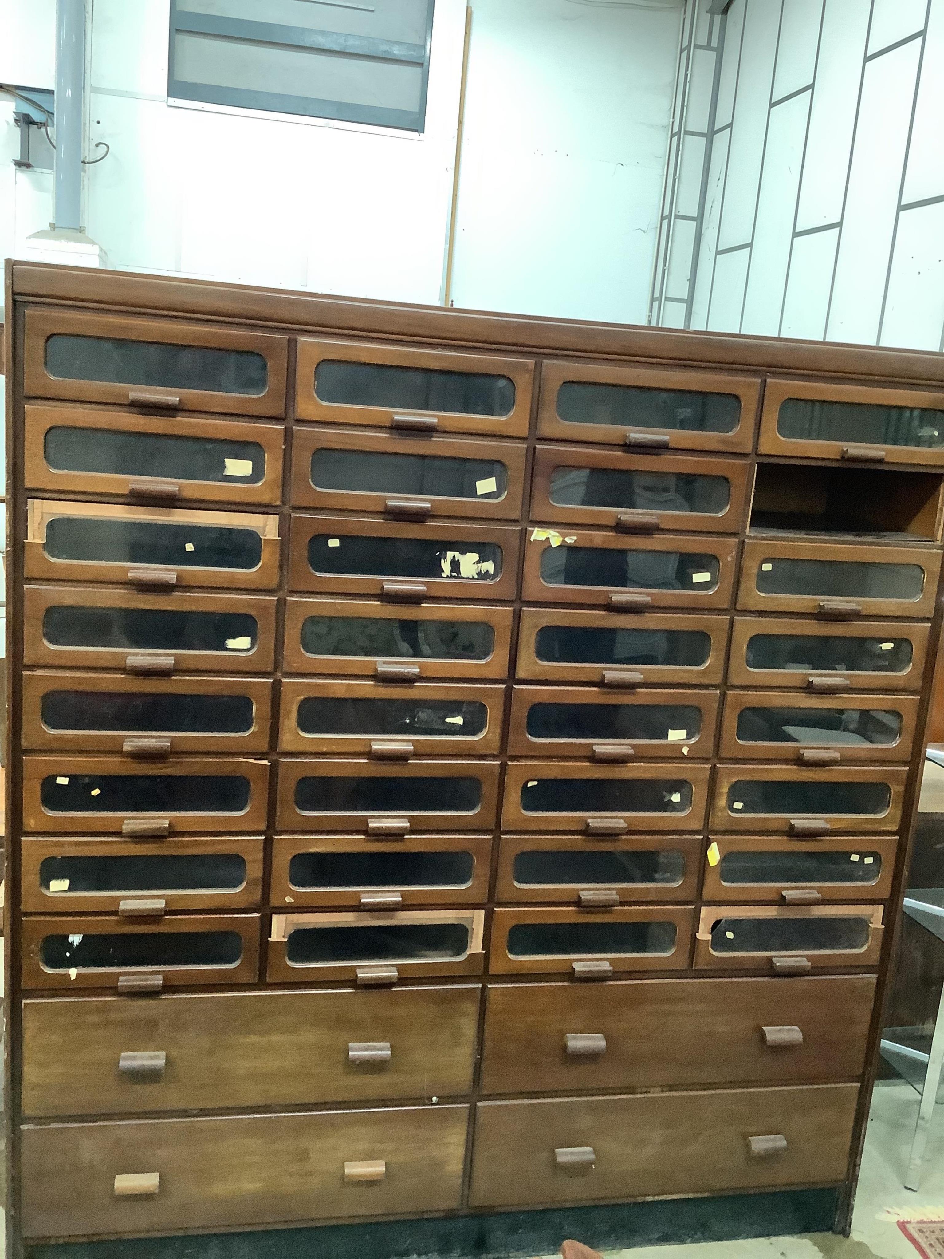A large mid century mahogany haberdasher's cabinet, width 183cm, depth 50cm, height 199cm. Condition - poor